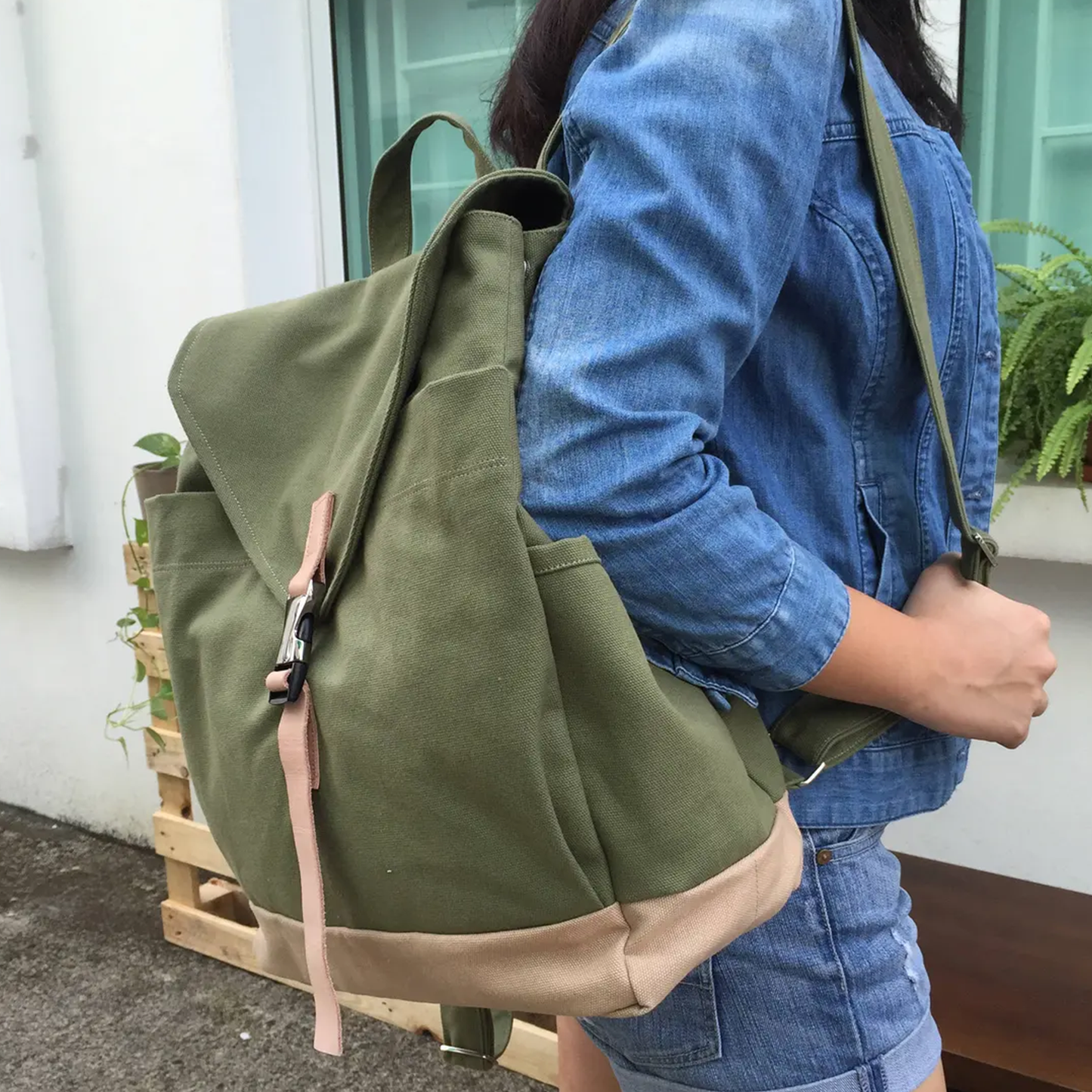 Moss Green And Beige Two-Tone Flap Backpack With Pale Pink Buckle Strap, Dual Side Slip Pockets And Rounded Fabric Top Carry Loop