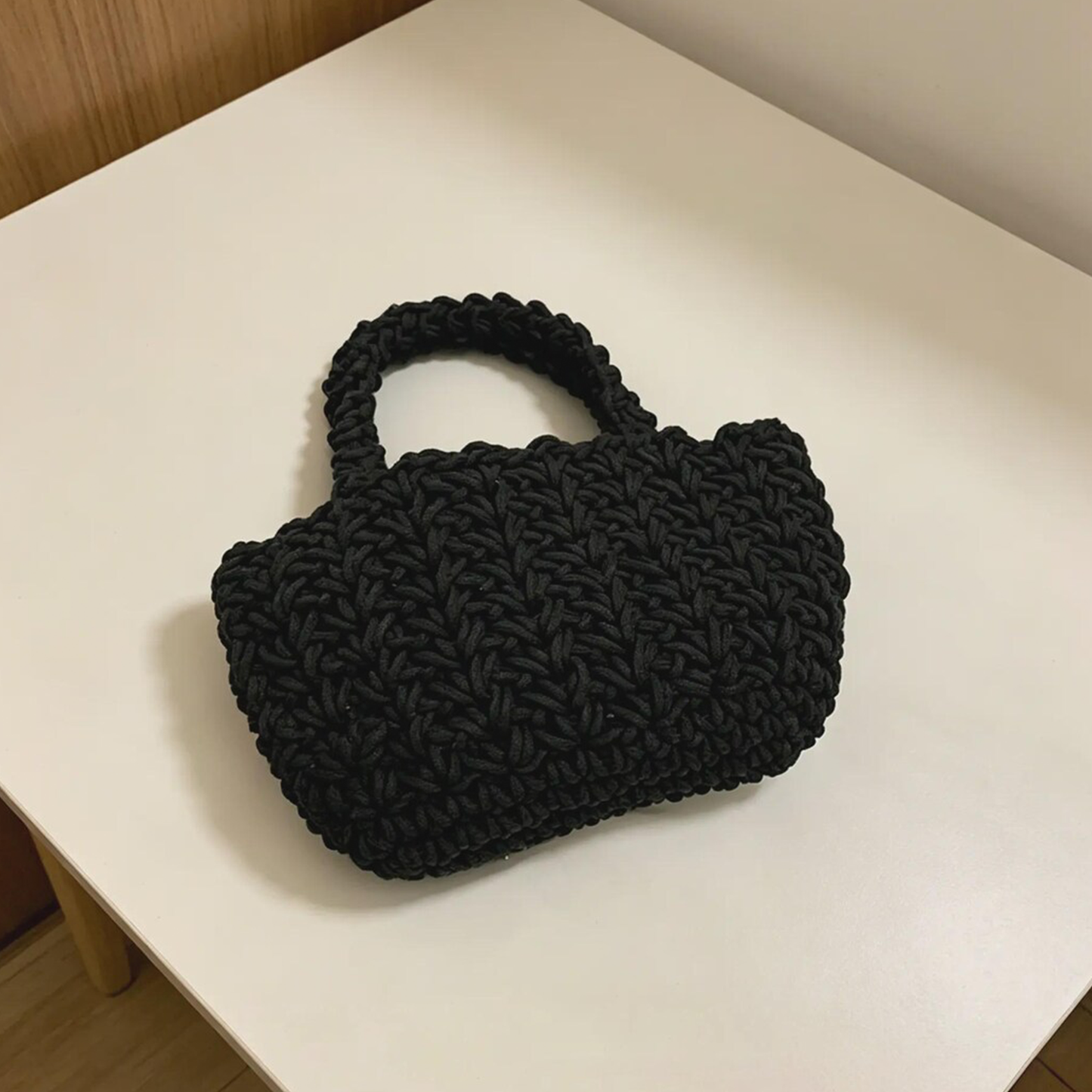 Solid Black Chunky Knit Woven Mini Tote With Integrated Looped Fabric Top Handle, Compact Rounded Inner Storage Cavity And Lightweight Streamlined Silhouette