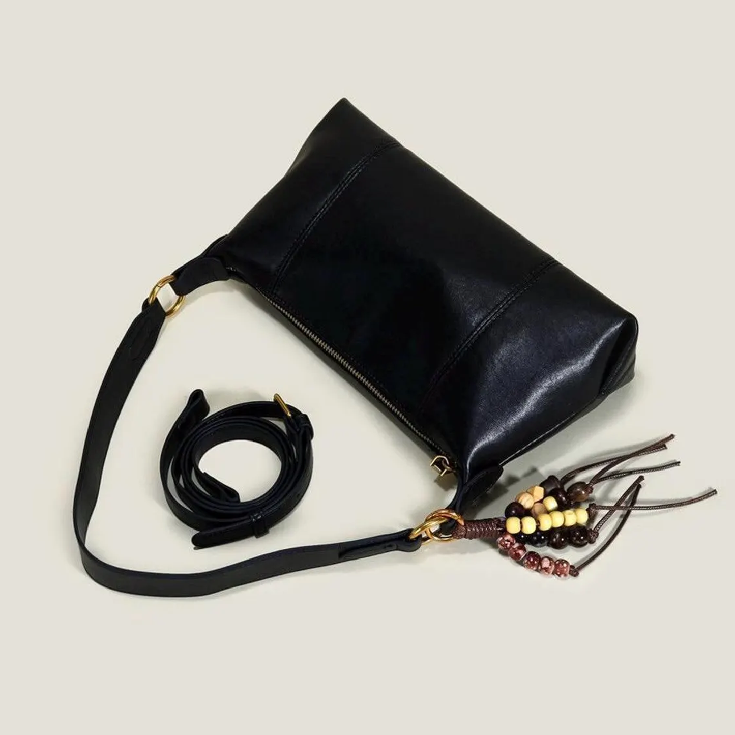 Solid Black Elongated Wrinkled Hobo Handbag With Gold Interlock Ring Hardware, Multi-Tone Bead Tassel Charm And Full Horizontal Zipper Closure