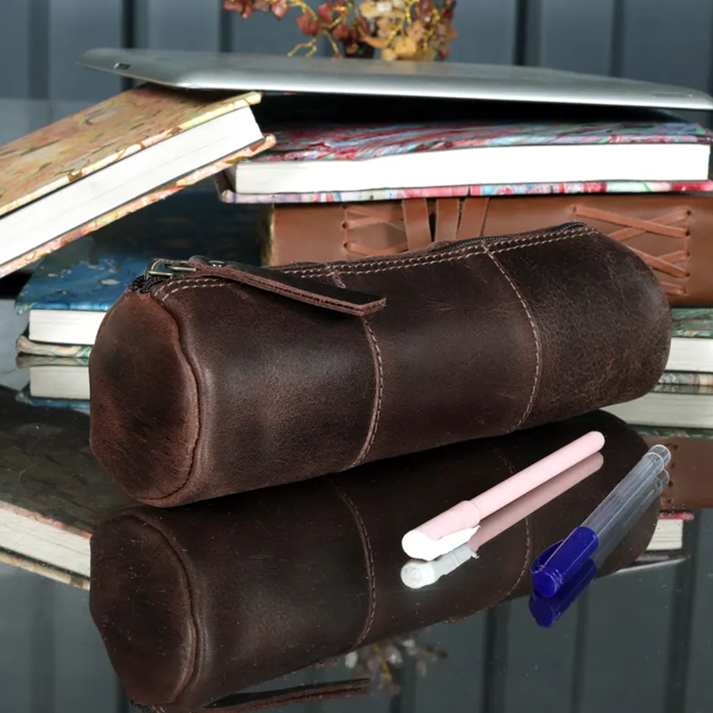 Weathered Dark Brown Cylindrical Stationery Pouch With Segmented Stitched Panels, Full Length Top Zipper And Metal Stud Reinforced Fabric Pull Tab
