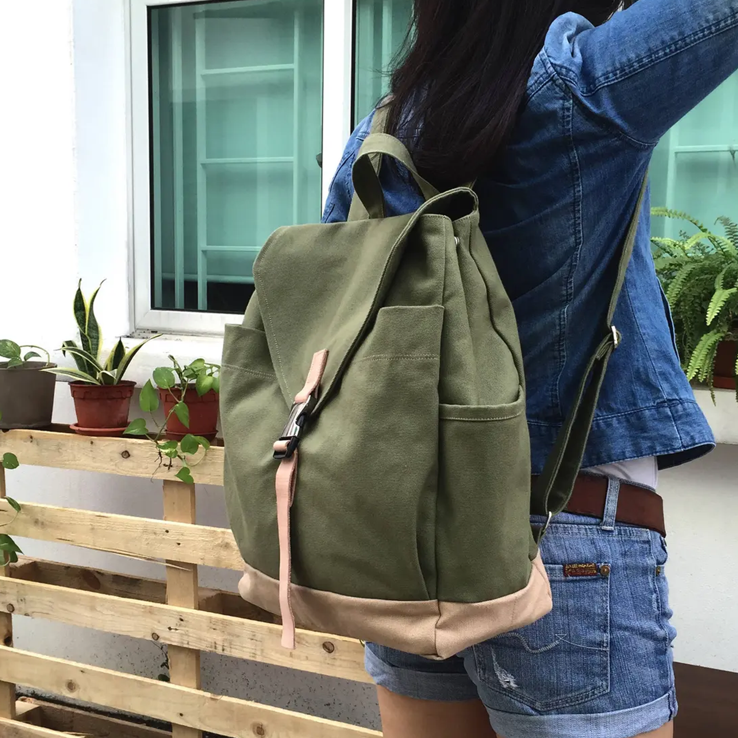 Moss Green And Beige Two-Tone Flap Backpack With Pale Pink Buckle Strap, Dual Side Slip Pockets And Rounded Fabric Top Carry Loop